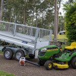 John Deere mower on Variant tipper trailer with ramps and cage sides - gardeners best tools.